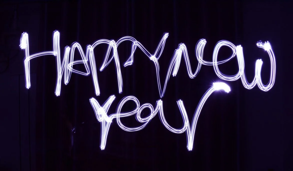 a neon sign that says happy new year