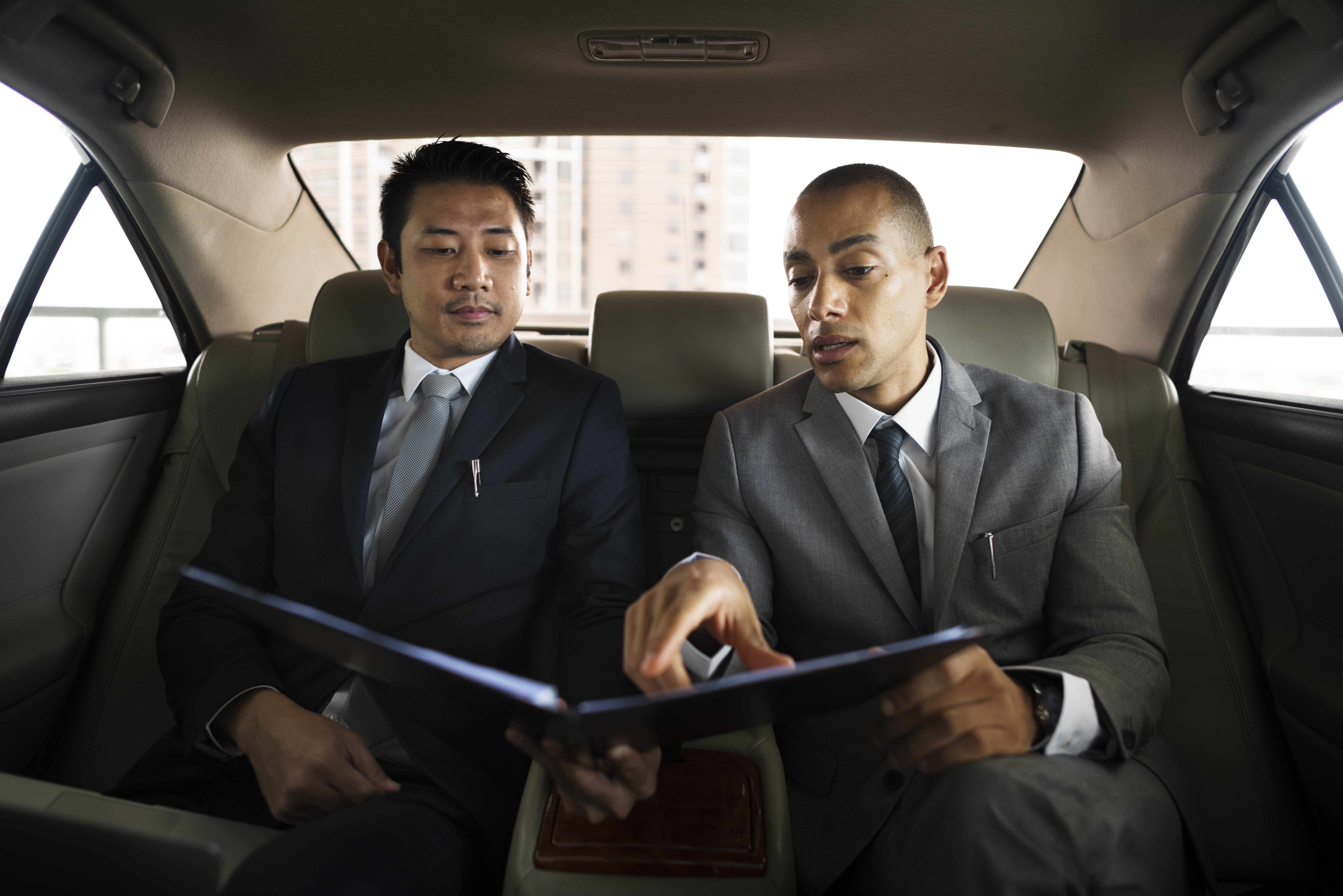 business men talk report inside car 2023 11 27 05 25 16 utc